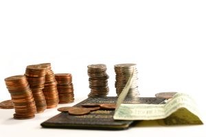stacks of coins and bill with passbook savings account isolated on white space
