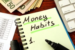 Notepad with word Money Habits. Saving and planning concept.